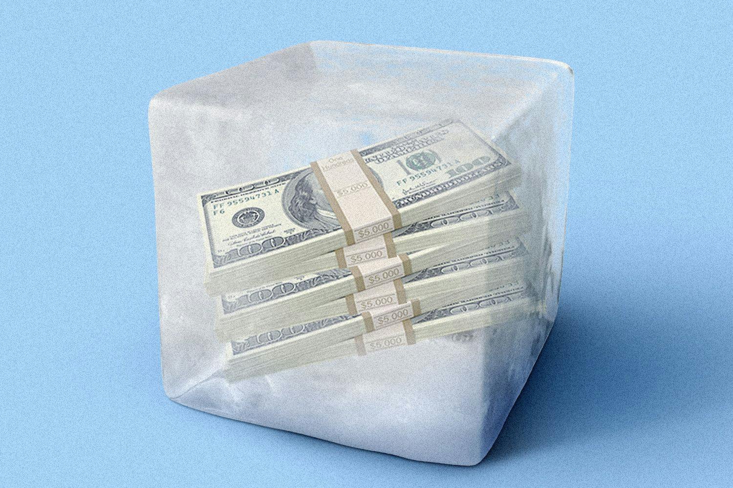 Stack of money frozen in ice cube